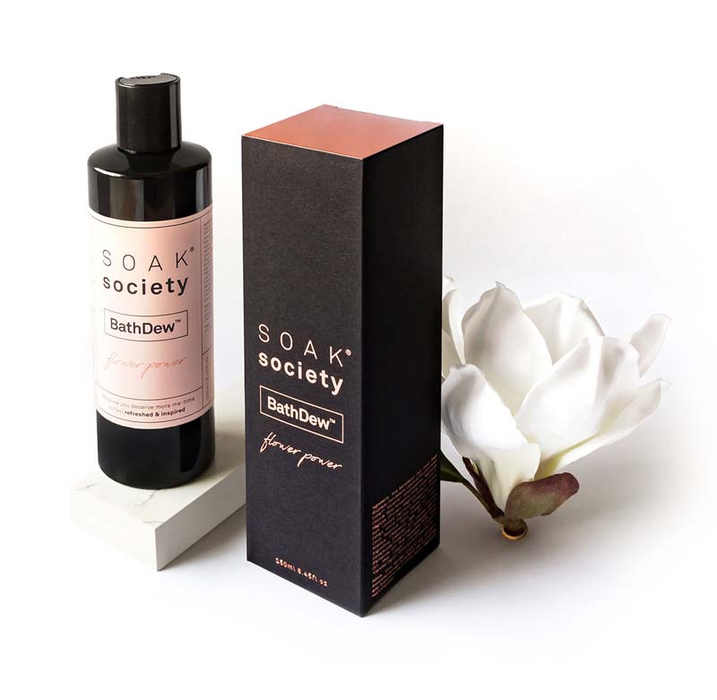Soak Society Bath Dew packaging with a white rose